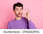 Portrait of attractive cheerful funny guy pretending like smoking cigarette isolated over pink pastel color background