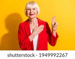 Small photo of Photo of aged woman happy positive smile hand on heart make oath promise swear isolated over yellow color background