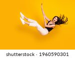 Full length body size photo of woman wearing casual clothes falling down isolated on vibrant yellow color background