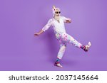 Full length body size view of nice funny cheerful man in pajama walking having fun isolated over violet purple color background