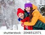 Photo of charming pretty marriage couple wear windbreakers embracing smiling having fun walking snowy weather outside park