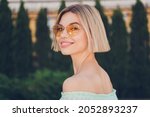 Profile side photo of young attractive girl happy positive smile wear sunglass summer nature outdoors