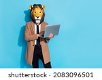 Small photo of Photo of weird incognito freak guy manager lion mask use device netbook search carnival news isolated over blue color background