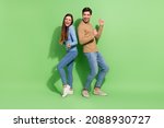 Small photo of Photo of funny cheerful inspired couple enjoy clubbing discotheque wear casual outfit isolated green color background