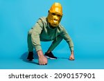Small photo of Photo of incognito intimidating guy sit fists squat wear gorilla mask sportswear isolated blue color background