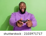 Photo of cool excited guy wear purple hoodie holding playstation ps open mouth isolated green color background