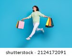 Full body photo of funny young brunette lady go shoping wear shirt pants sneakers isolated on blue background
