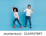 Full length body size view of attractive cheerful kids dancing moving having fun isolated over bright blue color background