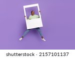 Full length photo of overjoyed good mood female take polaroid photo of herself isolated on violet color background