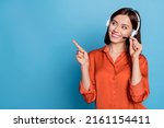 Portrait of attractive trendy cheerful girl help desk service showing copy space isolated over bright blue color background