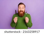 Small photo of Portrait of crazy positive man hold fork knife open mouth cant wait food isolated on purple color background
