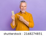 Small photo of Photo of senior man indicate finger meds painkillers promo recommend select isolated over violet color background