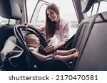 Small photo of Photo of peaceful satisfied mommy cute charming toddler sitting safety chair auto spend weekend together