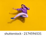 Full length body size view of handsome trendy strong guy jumping fighting isolated on bright yellow color background