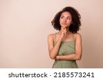 Small photo of Photo of clever dreamy lady arm touch face has question doubt idea unsure look empty space isolated on beige color background