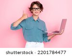 Small photo of Portrait of positive cheerful girl bob hairdo wear blue blouse eyeglasses hold laptop showing thumb up isolated on pink color background