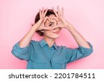 Portrait of adorable nice person arms fingers demonstrate heart symbol eye isolated on pink color background