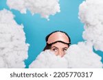 Portrait of attractive girly girl waking up hiding behind fluffy clouds flying isolated over bright blue color background