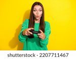 Photo of impressed person arms hold controller pouted lips play games isolated on yellow color background