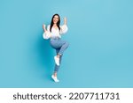 Small photo of Full body portrait of overjoyed cheerful lady raise fists accomplishment empty space isolated on blue color background