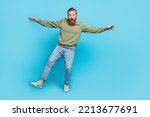 Small photo of Full size photo of nice young guy balancing one leg falling scared height tightrope wear khaki look isolated on cyan color background