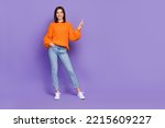 Full size photo of positive gorgeous girl indicate finger empty space isolated on violet color background