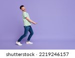 Full body photo of attractive man carry empty space invisible heavy box dressed stylish gray garment isolated on purple color background