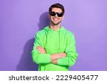 Photo of rich positive influencer hold folded hands wear green pullover expensive sunglasses rayban nightclub isolated on purple color background