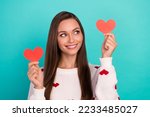 Portrait of gorgeous nice girl toothy smile look arms hold little heart cards isolated on cyan color background