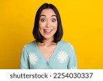 Photo of good mood astonished nice woman with bob hairdo dressed blue pullover staring lick teeth isolated on yellow color background