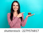 Photo of nice cheerful lady toothy smile direct finger arm hold muffin dessert isolated on teal color background