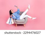 Small photo of Full body portrait of attractive funny lady sit chair hold mall bags take selfie smart phone isolated on pink color background