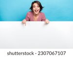 Small photo of Photo of young crazy woman indicating fingers empty space banner crazy proposition product placement isolated on blue color background
