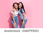 Small photo of Portrait photo of two laughing carefree girls best friends hugs support trust relationships family isolated on pink color background