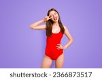 Small photo of Party mood Portrait of foolish playful girl gesturing v-sign near winking eye showing tongue out looking at camera isolated on vivid yellow background