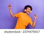 Photo of handsome overjoyed chilling guy dancing listen earphones ac dc rock roll music itunes advert isolated on purple color background