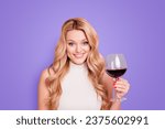 Small photo of Portrait of foolish cheerful girlfriend having glass with dry semi-sweet red wine in hand looking at camera isolated on pink background