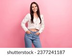 Photo of candid pretty woman brunette hair latin model posing hands put pockets her denim jeans crop top isolated on pink color background