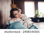 Photo of satisfied adorable girl sitting comfy sofa have good mood pastime morning chill apartment inside