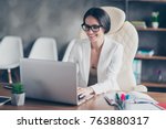 beautiful clever cute charming attractive elegant owner of big company has online meeting with international business partners, she is sitting at the table at workstation