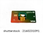 Small photo of Cairo, Egypt, May 25 2022: Selective focus of National bank of Egypt Al Ahly prepaid visa wireless card banking services isolated on white background