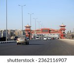 Small photo of Cairo, Egypt, September 10 2023: Shinzo Abe axis patrol highway in Egypt with a pedestrian bridge finished in traditional Japanese architectural style, the traffic highway named on former Japanese PM