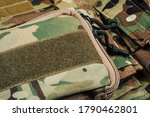 Military body armor on wooden background close up