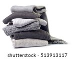 Stack of various sweaters isolated on white background
