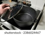 Small photo of Stockpot - Glass lid raised by hand. Non-stick marble coating inside.