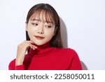 Beauty portrait of young Asian woman in red knit