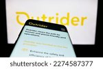 Small photo of Stuttgart, Germany - 03-07-2023: Mobile phone with website of US company Outrider Technologies Inc. on screen in front of business logo. Focus on top-left of phone display. Unmodified photo.