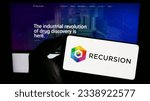 Small photo of Stuttgart, Germany - 07-19-2023: Person holding cellphone with logo of US company Recursion Pharmaceuticals Inc. on screen in front of business webpage. Focus on phone display. Unmodified photo.