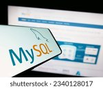 Small photo of Stuttgart, Germany - 07-13-2023: Smartphone with logo of relational database management system MySQL on screen in front of website. Focus on center of phone display. Unmodified photo.