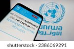 Small photo of Stuttgart, Germany - 11-03-2023: Mobile phone with website of United Nations Plalestine refugees agency UNRWA in front of logo. Focus on top-left of phone display. Unmodified photo.